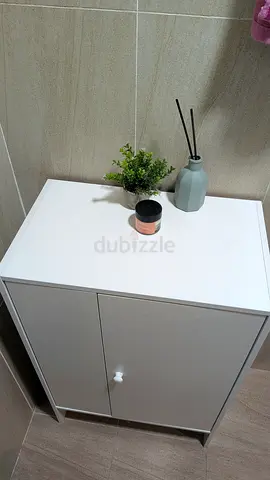 Compact white storage cabinet with doors - good condition