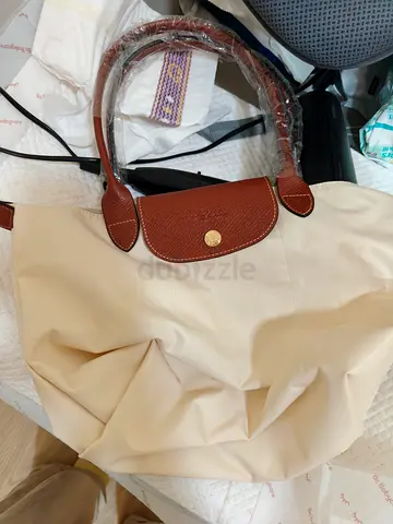 Beige tote bag with brown leather handles (good condition)