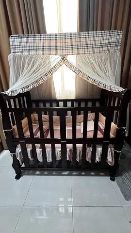 Dark wood baby crib with canopy and bedding - sturdy crib with height adjustable bedding for safety