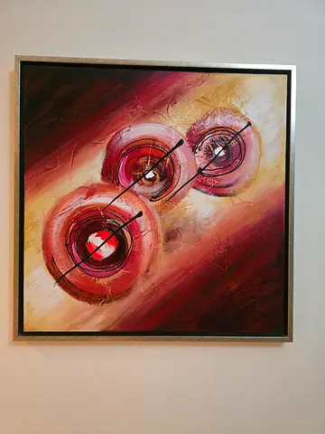 Abstract textured circular painting in warm tones — framed wall art