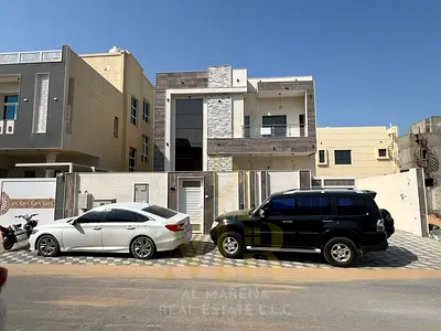 Luxurious, fully furnished modern villa for sale in Al Yasmeen area, Ajman. The price includes electricity, water, air conditioning, and furniture.