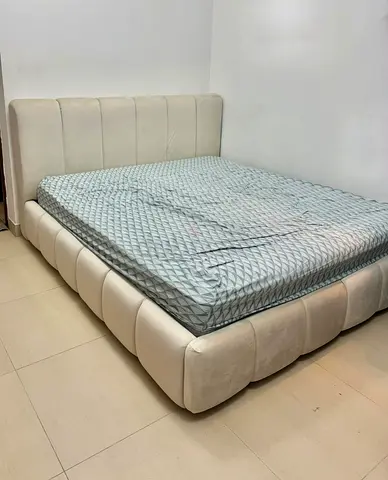 Cream upholstered king-size bed frame with padded headboard/ free Mattress