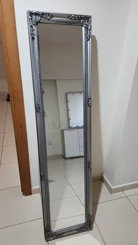 Full-length decorative wall mirror with ornate silver frame