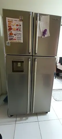 GE Stainless Steel Side-by-Side Refrigerator with Water Dispenser - Good Condition