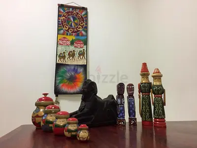 Mixed vintage collectibles set — wooden figurines, nesting dolls, sphinx statue