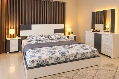 Modern white and gray queen bed set with dresser and nightstands