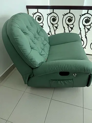 Green upholstered recliner/armchair in good condition