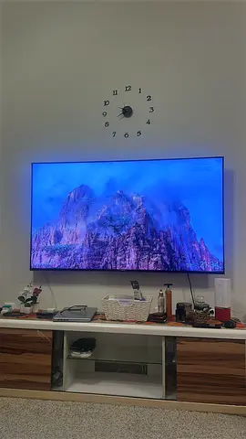 65-inch LED Smart TV mounted on wall - Good condition