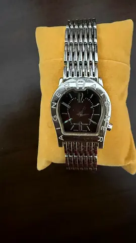 Silver-tone Aigner wristwatch with horseshoe bezel, metal bracelet for small wrists.