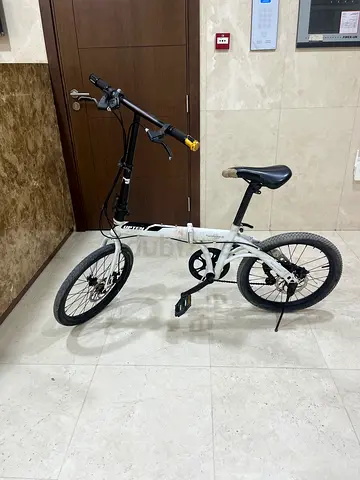 Lightly used white adult folding bicycle - compact city bike