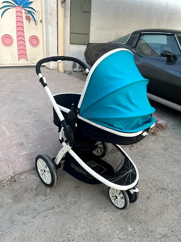 Lightweight turquoise standard baby stroller with storage basket