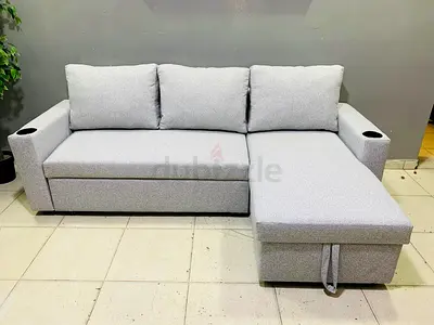Light grey L-shaped sofa with chaise and cup holders - good condition