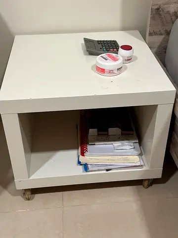 White bedside nightstand with open shelf and casters