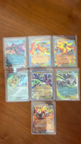 Collection of 7 Holo Pokémon EX/GX/TAG Team Cards in Hard Sleeves