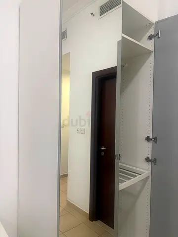 White mirrored wardrobe with shelves and hanging space - excellent condition
