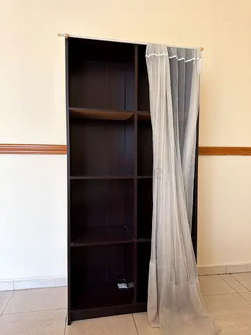 Dark wood 8-cube shelving unit / bookcase with a curtain to cover it (IKEA-style)