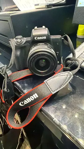 Canon EOS DSLR with 18-55mm lens and strap - used