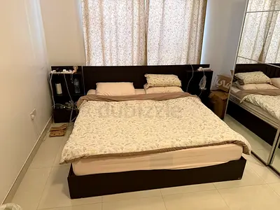 Double bed with attached headboard shelves and storage - dark wood