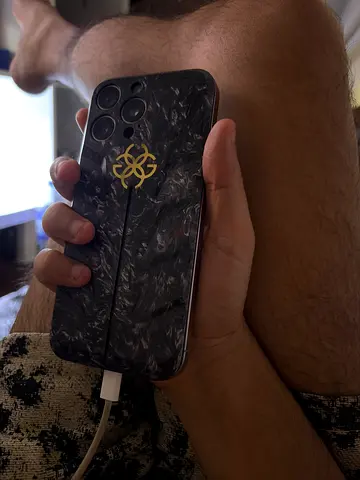 Used Apple iPhone with decorative black marble case (working) - UAE