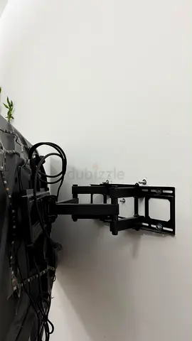 Adjustable full-motion TV wall mount bracket (installed)