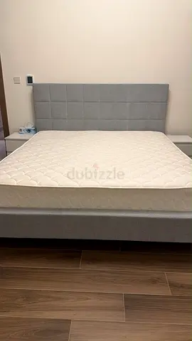 Bed with mattress and side table slightly used