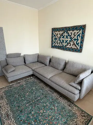 Light grey L-shaped sofa with cushions - good condition