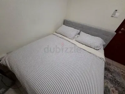 Queen upholstered bed frame with mattress without bedding (grey headboard)