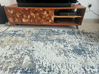 Modern textured wooden TV unit with geometric carved doors