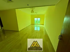 2BR in Nuaimiya 3, balcony, central AC, free parking, near schools and malls. AED 49,008 negotiable.