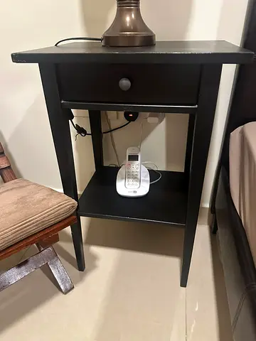 Simple black bedside table with drawer and shelf