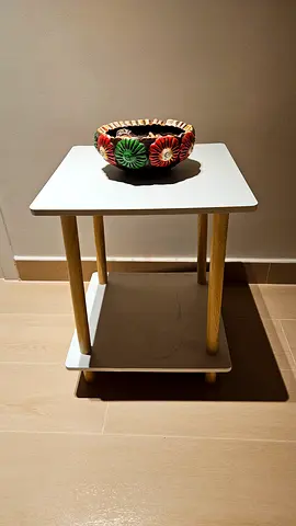 Simple white side table with wooden legs