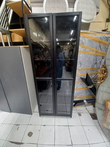 Tall black mirrored cabinet with glass doors - good condition