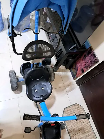 Blue toddler tricycle with parent handle and canopy - used