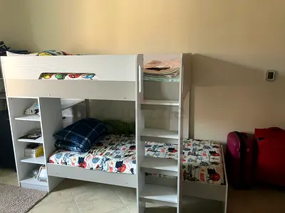 White wooden bunk bed with built-in shelves — Excellent condition