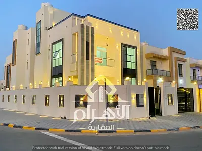 Villa for sale in Al Zahia, Ajman. Features 4 master bedrooms, a roof terrace, a majlis, a living area, and a maid’s room. Available for freehold owne