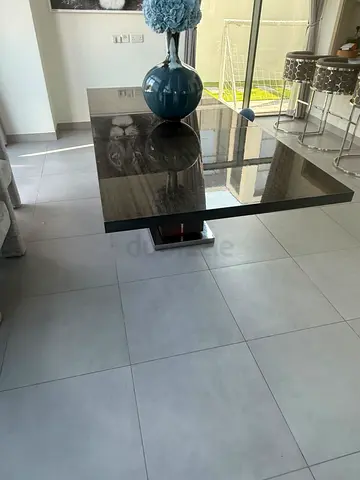 Modern dark wood dining table with pedestal base. Can seat 8-10. Can be extended
