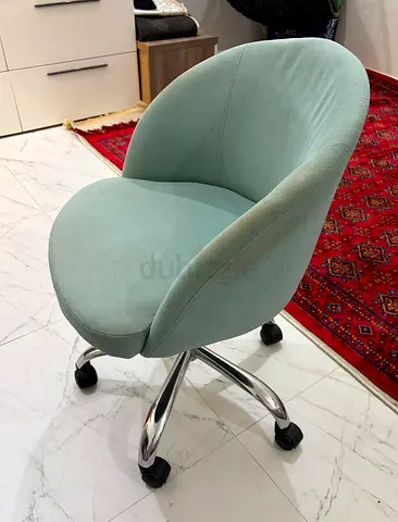 Light green swivel office chair on wheels - good condition