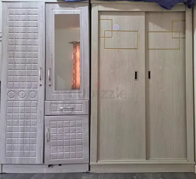 Two wooden wardrobes - large sliding wardrobe and mirrored cabinet.