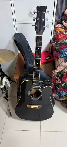 Used black acoustic-electric guitar with soft case - playable condition