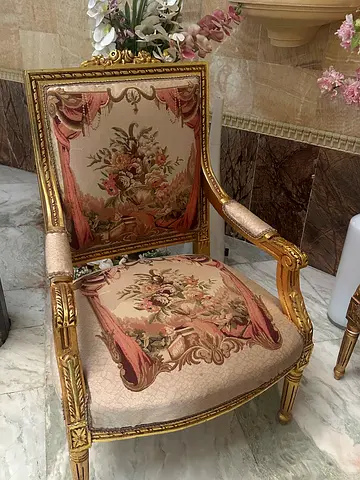 Pair of vintage French-style carved wooden armchairs with floral upholstery