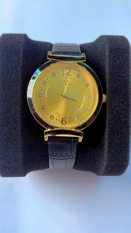 Gold-tone women's analog wristwatch with black leather strap