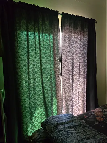 Pair of dark patterned fabric curtains - used, good condition