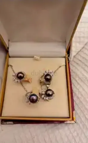 Silver necklace and matching stud earrings set with dark pearls