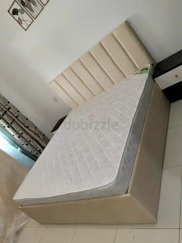 Beige upholstered king size double bed with mattress - good condition