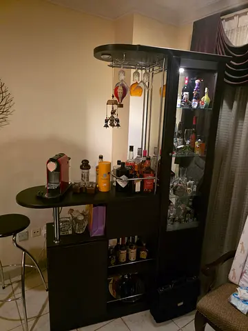 Dark wood multifunctional entertainment/bar cabinet with glass display