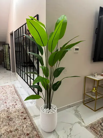 Tall artificial indoor plant in white pot - modern decorative piece