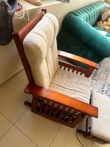 Solid wood armchair with matching footstool, beige upholstered cushions