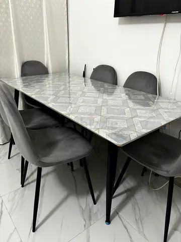Marble-effect dining table with 4 grey upholstered chairs - good condition