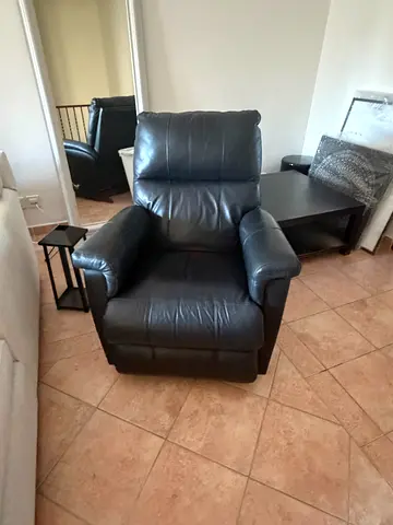 Black leather recliner armchair in good used condition