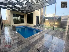 Villa for sale in Al-Aliya, Ajman. Features 5 master bedrooms, a majlis, 3 living areas, a maid’s 